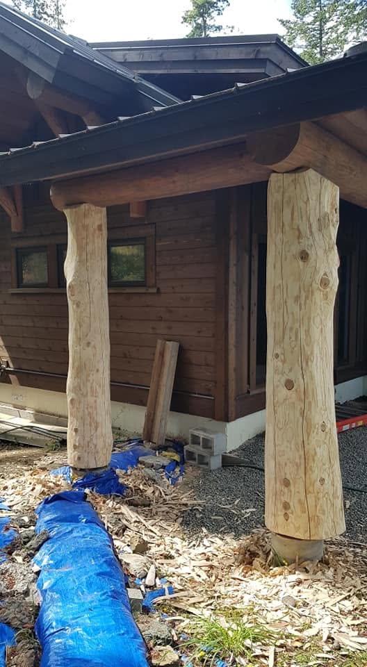 Hand-peeled log posts supporting a covered porch
